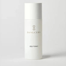 Load image into Gallery viewer, White skincare bottle labeled 'Danucera D22 Tonic' on a light gray background
