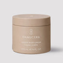 Danucera Luxera Body Cream in a matte taupe-beige jar with white text, set against a solid light gray background.