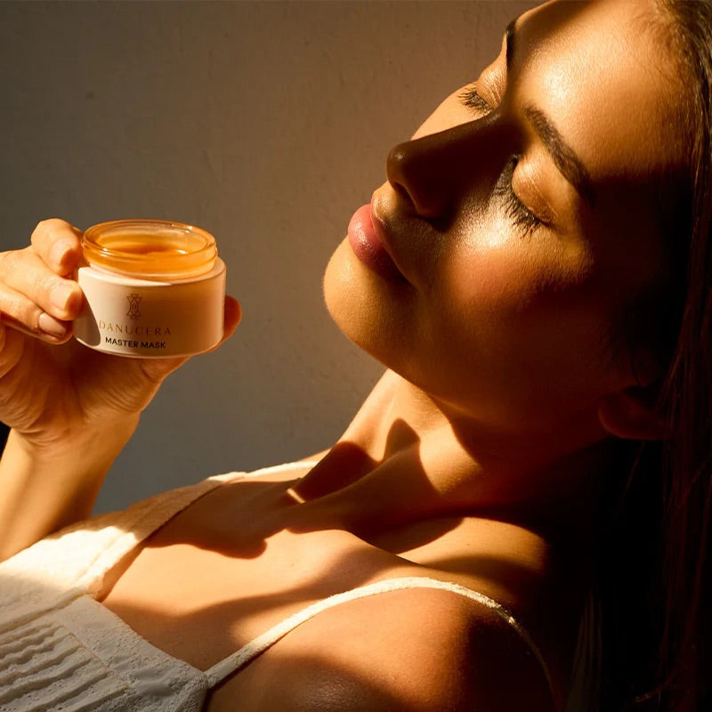Woman holding a jar of cream with a warm glow