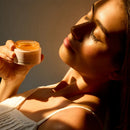Woman holding a jar of cream with a warm glow